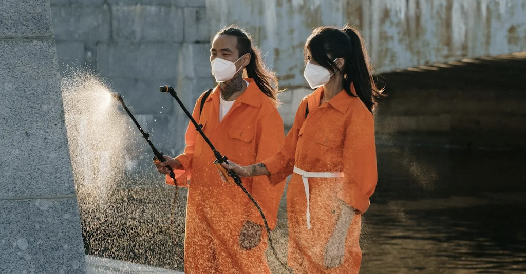 Woman and man spraying water