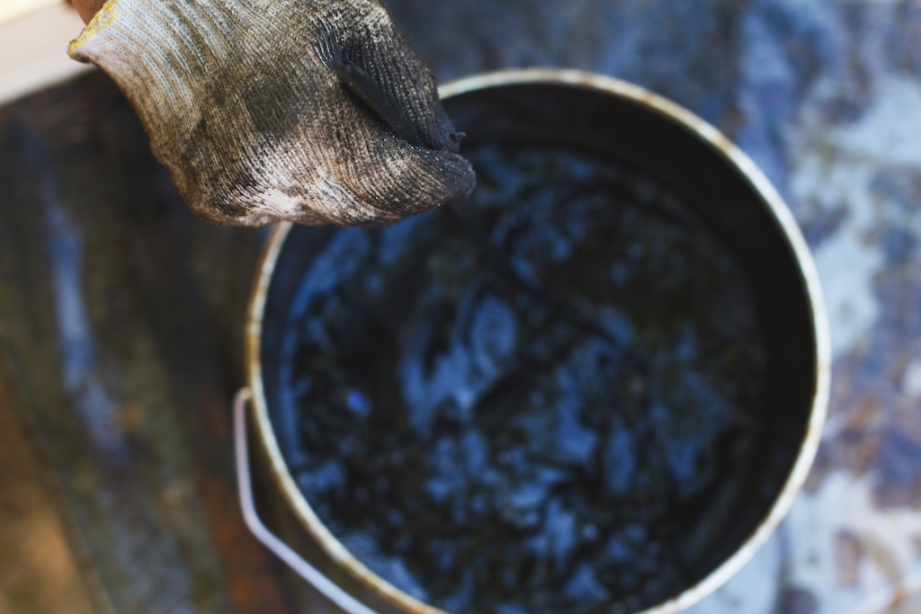 Can of brown paint is in the yard