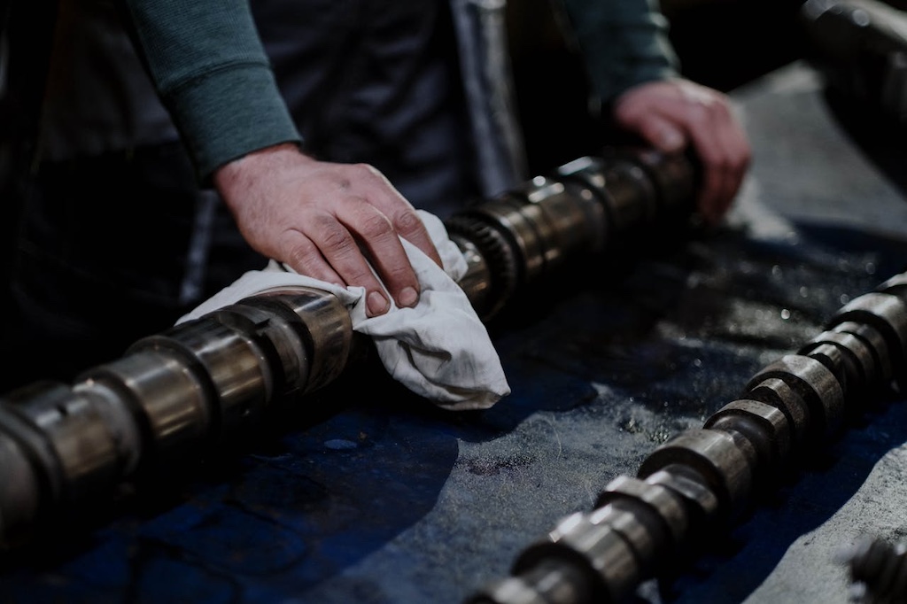 Person wiping a part of a metal engine