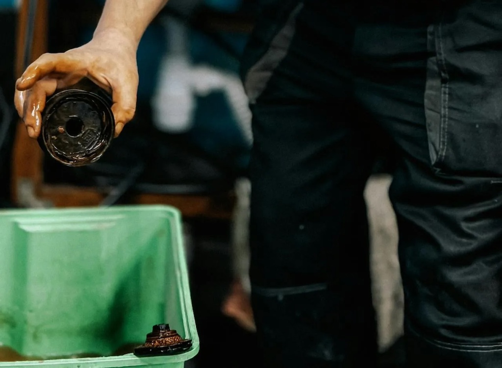 Mechanic inspecting engine component in workshop