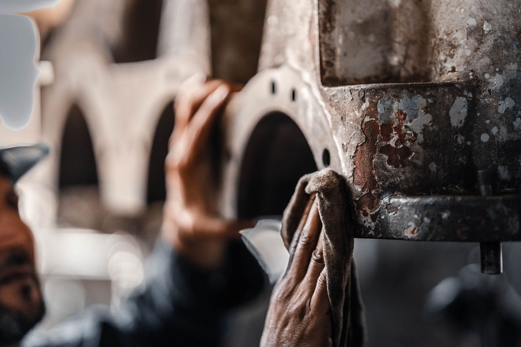 Man maintaining industrial machinery in workshop
