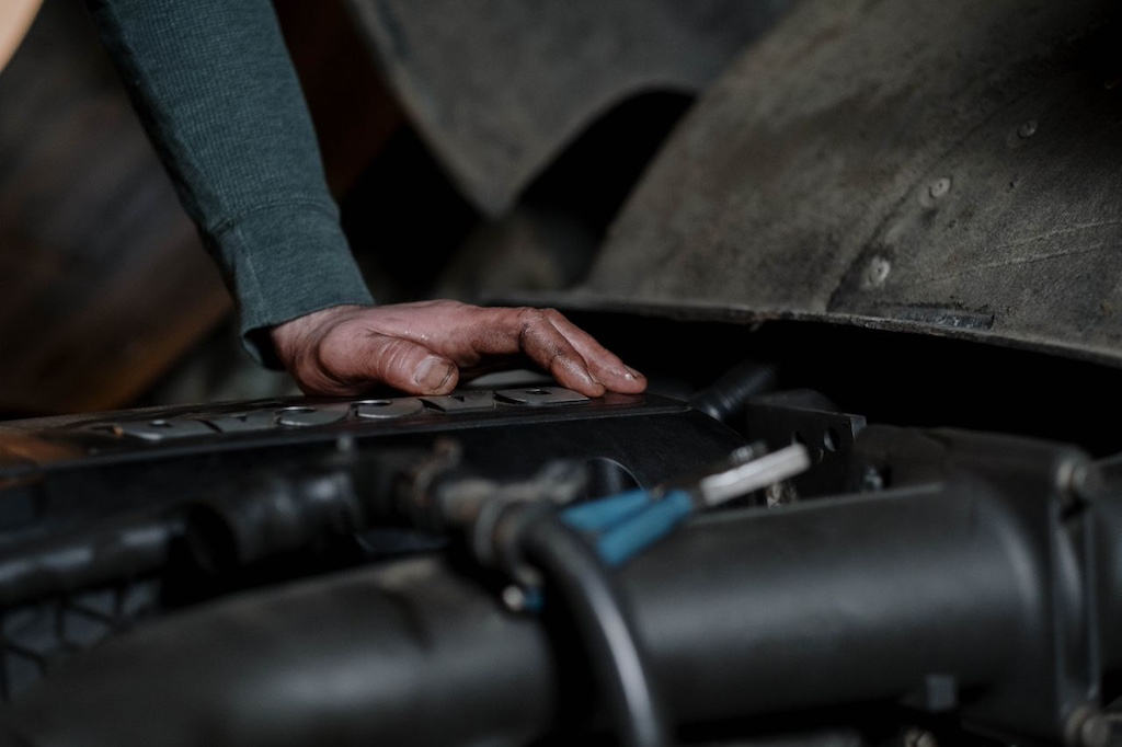 Mechanic checking engine of car