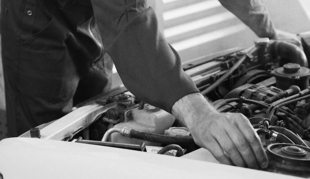 Photo of mechanics hand fixing a car