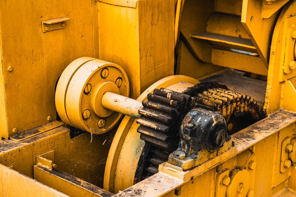 Close up of industrial machinery with yellow metal components
