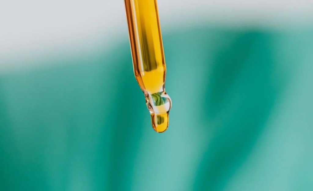 Brown glass bottle with liquid and pipette