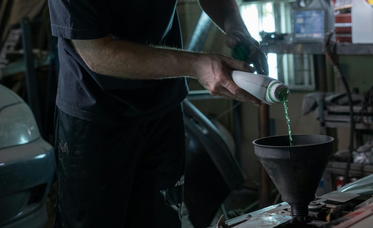 a man pouring fuel into the tank