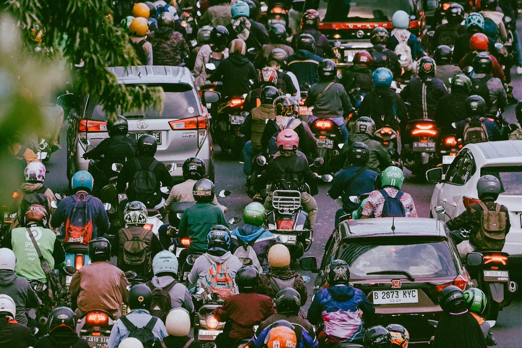 motorcycle and cars on a busy street